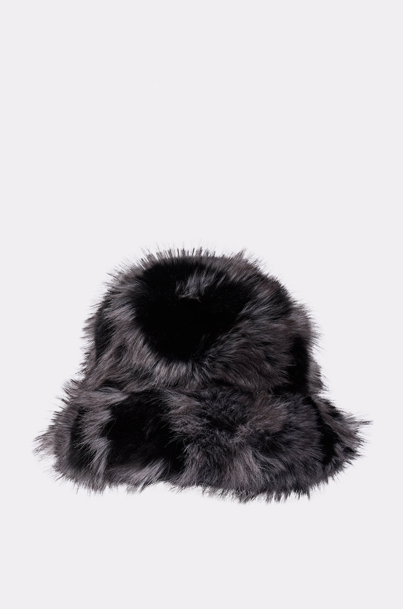 The ARLO FAUX FUR BUCKET HAT, featuring soft black and gray faux fur, is shown against a light gray background—perfect for adding cozy style to your winter look.