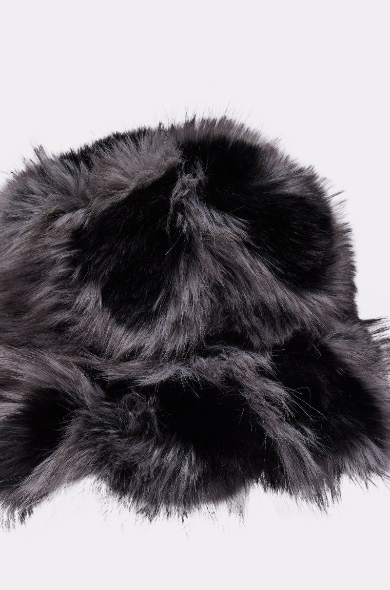 The ARLO FAUX FUR BUCKET HAT, shown in black and gray with a soft, fluffy texture, is the perfect winter accessory. Displayed close-up against a plain white background.