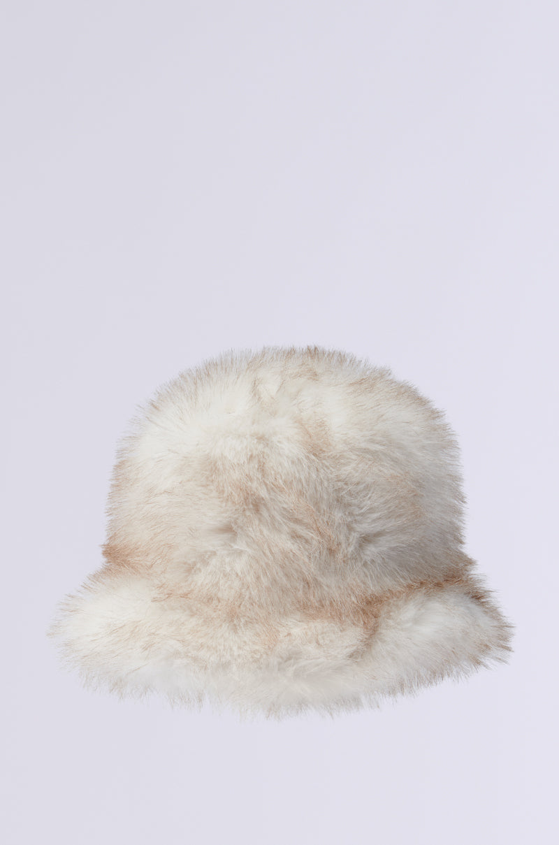 The TOASTIE FAUX FUR BUCKET HAT is a chic accessory that showcases fluffy white and beige tones on a light grey backdrop.