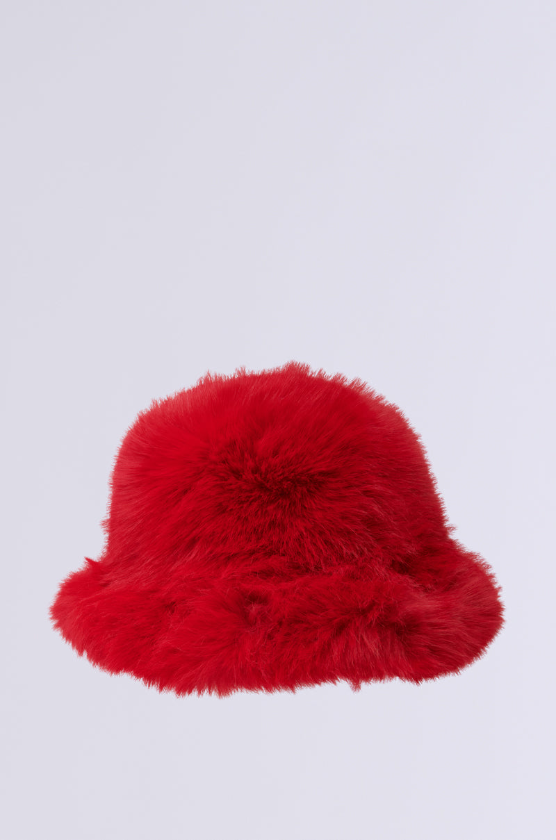 The LOOK AT ME NOW FAUX FUR HAT is showcased on a simple light gray background, its vibrant red color and fluffy texture emphasized by its full and plush design, making it a perfect accessory for cold weather. 2