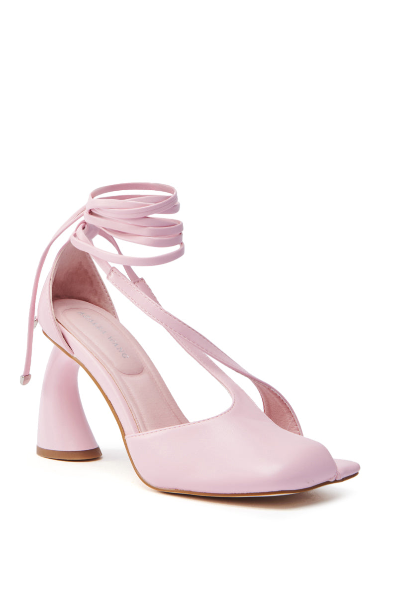 Embrace the balletcore trend with AZALEA WANG BUIKY pink chunky heel pumps in faux leather. These stylish shoes feature a unique curved heel, wrap-around ankle straps, and a sleek open-toe design for a modern twist on classic elegance.