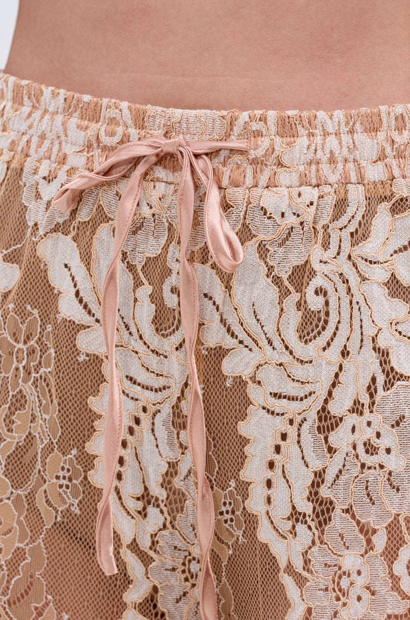 Close-up of the waistband of the RESORT VIBES WIDE LEG PALAZZO PANT, showcasing a pink satin drawstring and delicate floral lace overlay on a nude background—ideal for chic resort style. 7