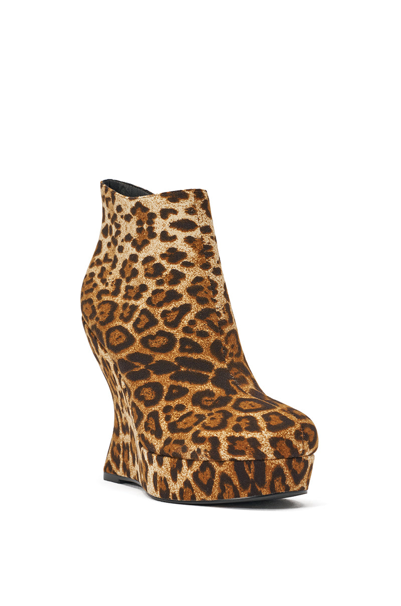 The AZALEA WANG CADY LEOPARD PRINT WEDGE BOOTIE features a bold leopard print, high wedge heel, rounded toe, seamless design, and convenient ankle zip closure. 4