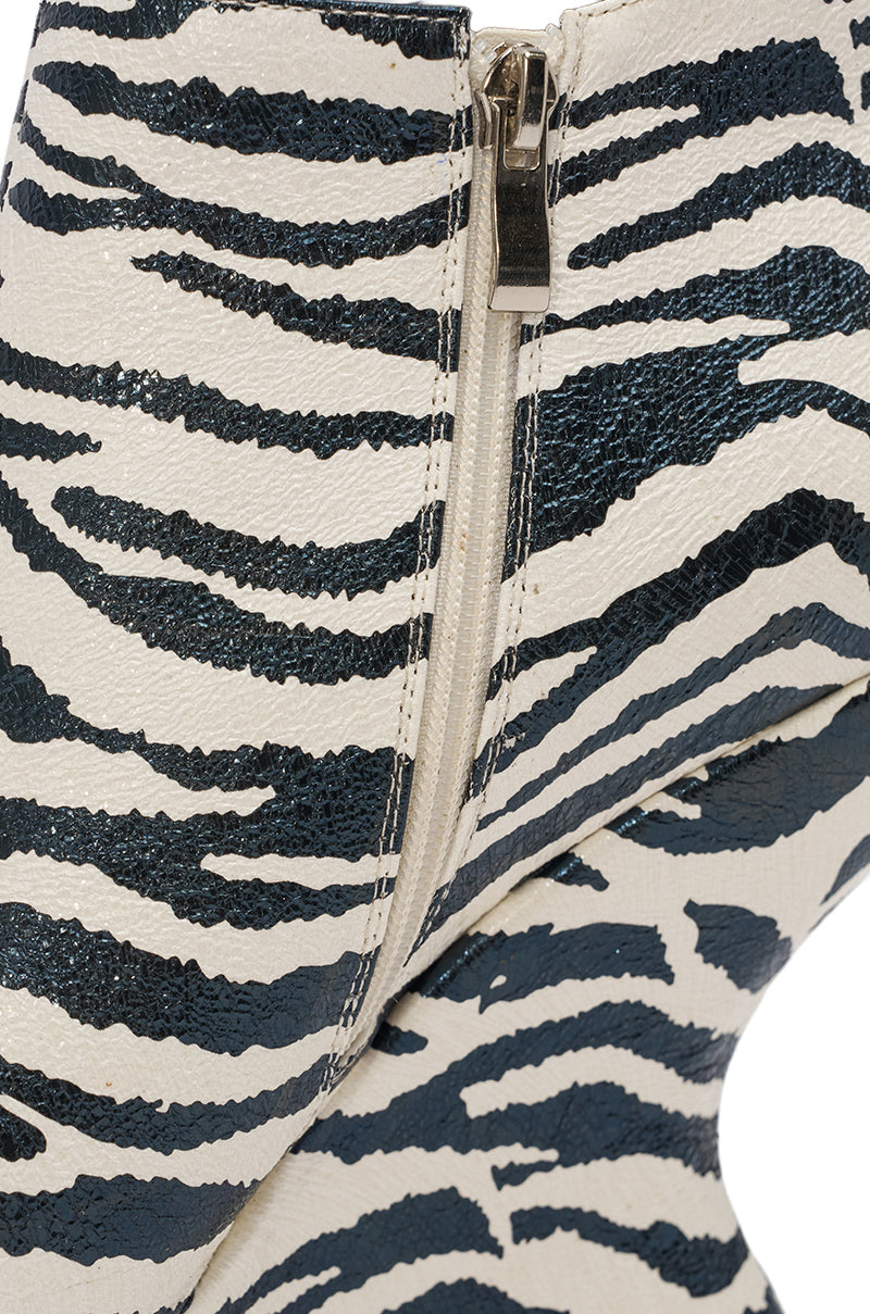 Close-up of the AZALEA WANG ZEBRA PU PRINT WEDGE BOOTIE, featuring black and white zebra print in stylish faux leather with a visible side zipper. 5