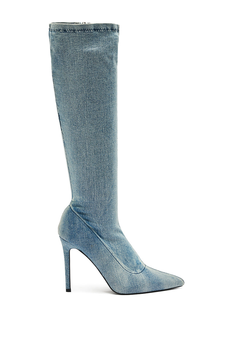 The AZALEA WANG CALANA STRETCH DENIM KNEE HIGH BOOT features a pointed toe and sleek stiletto heel, shown in profile against a white background.