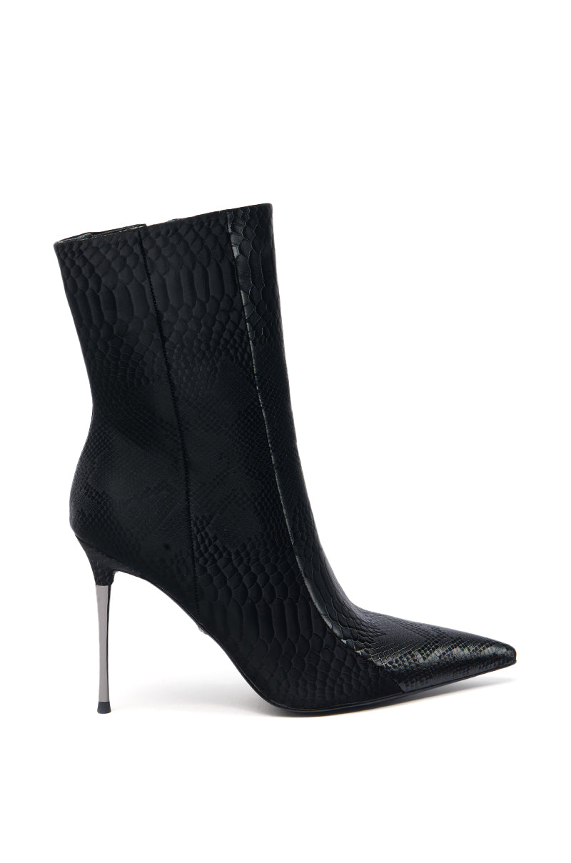 The AZALEA WANG CALEAN BLACK METAL STILETTO HEEL BOOTIE is a sleek, black faux leather bootie with a pointed toe, snakeskin texture, and thin stiletto heel, shown on a white background.
