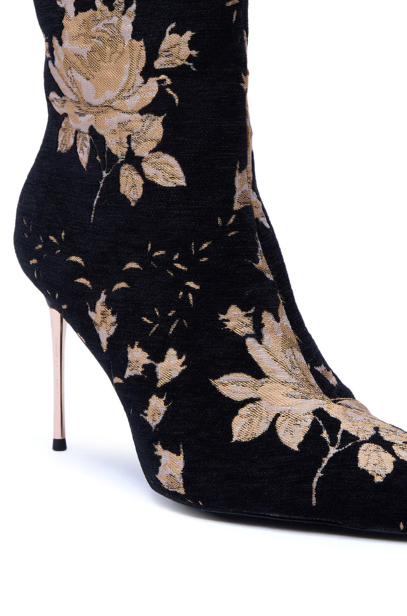Close-up of the AZALEA WANG CALEAN BLACK MULTI BROCADE STILETTO BOOTIE, showcasing a black floral brocade design with an ornate gold pattern and a slim metallic stiletto heel for added elegance. 6