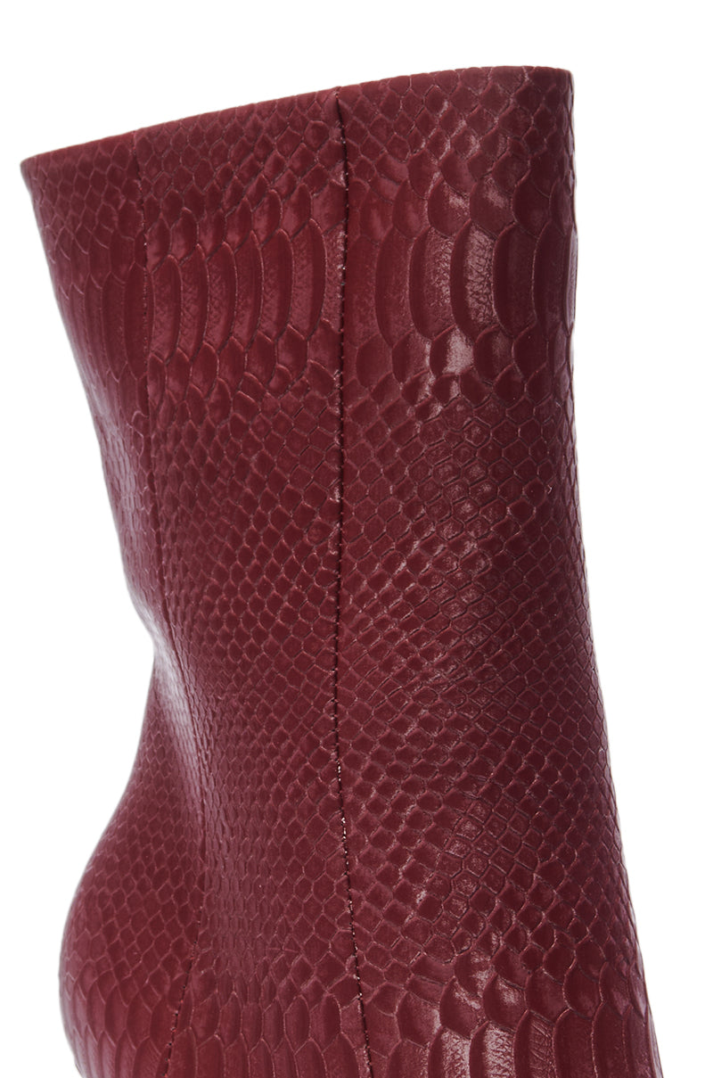 Close-up of the AZALEA WANG CALEAN BURGUNDY BOOTIE featuring a faux snakeskin texture and a vertical side seam for added detail.