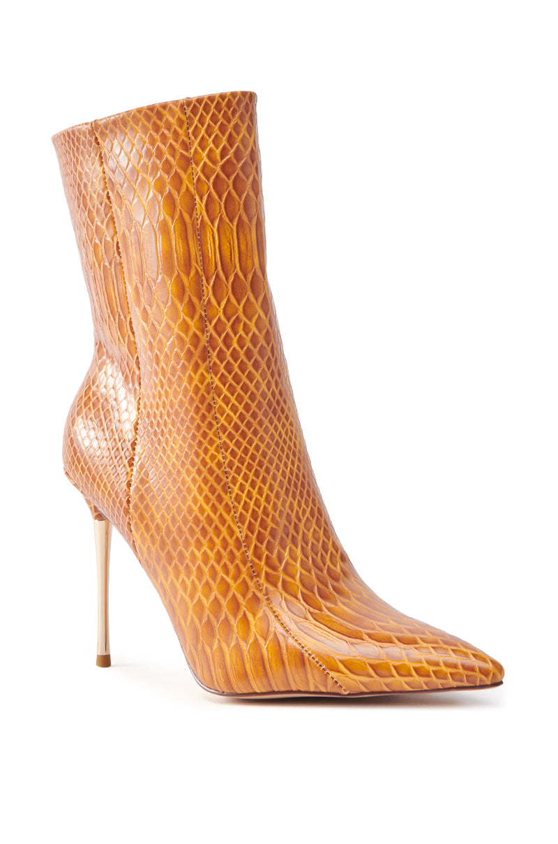The AZALEA WANG CALEAN ORANGE STILETTO BOOTIE features a chic pointed toe and a rich tan snakeskin pattern, crafted from luxe faux leather to add sophistication to any outfit.