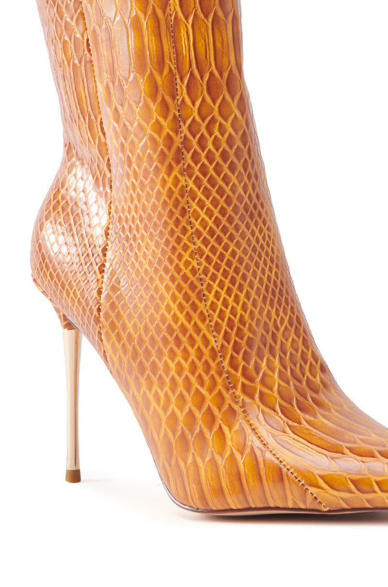 Close-up of the AZALEA WANG CALEAN ORANGE STILETTO BOOTIE, featuring a glossy brownish-yellow snakeskin pattern. The narrow metallic heel contrasts beautifully with the textured design, lending an elegant look to its smoothly curving silhouette.