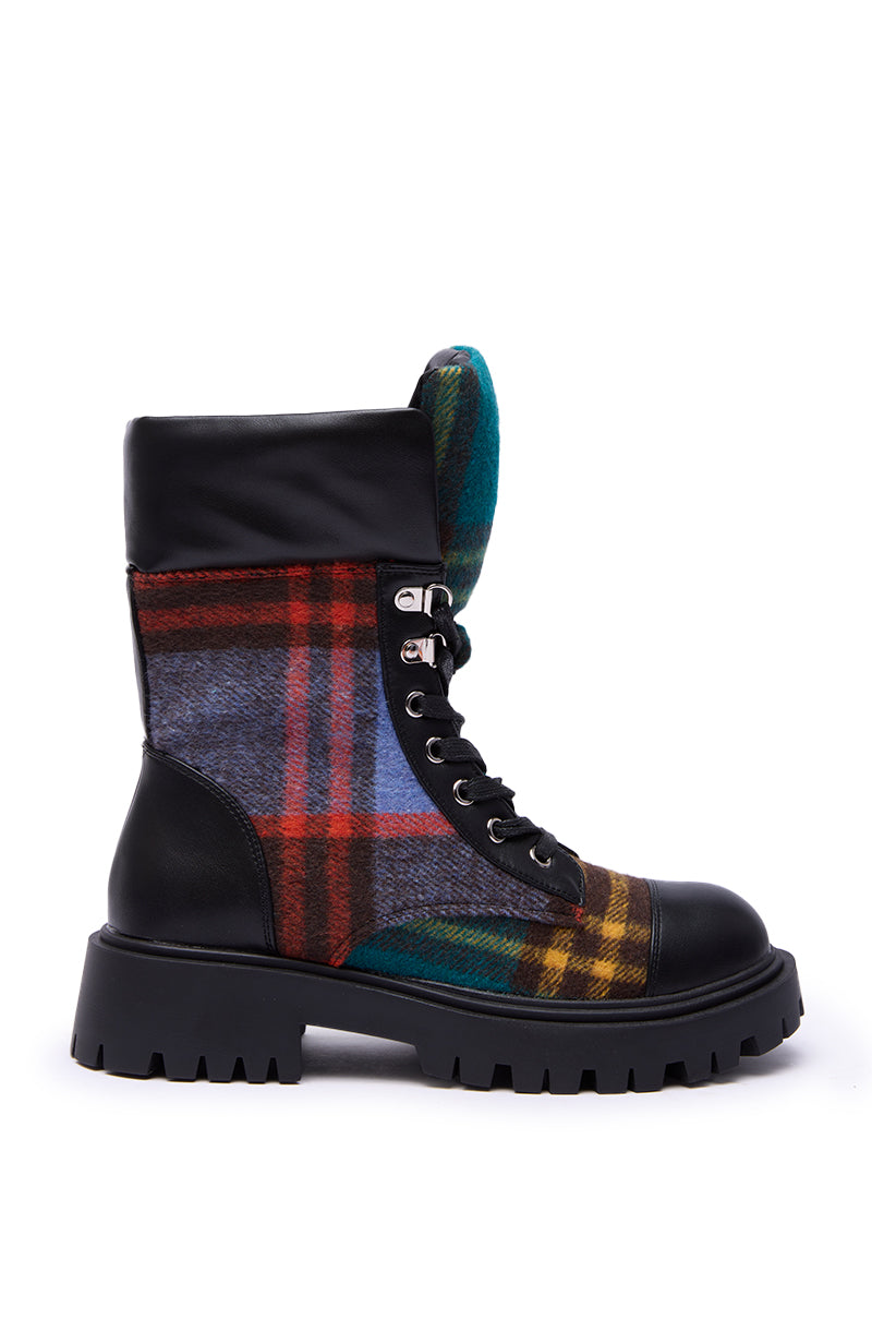 The AZALEA WANG CALIBAN BLACK MULTI PLAID COMBAT BOOTIE features a chunky lug sole, black faux leather toe, heel, and upper, with multicolored plaid panels in red, blue, green, and yellow. Finished with black laces and silver eyelets.