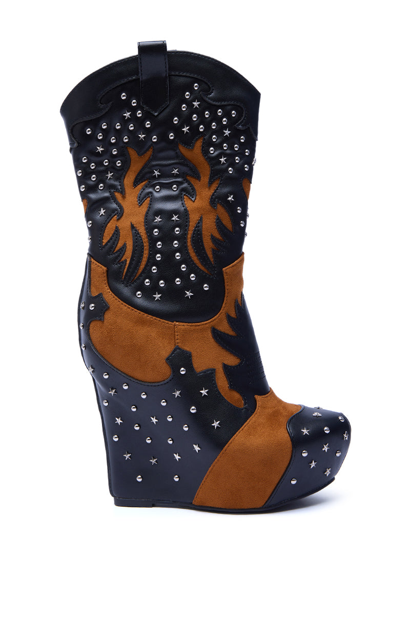 The AZALEA WANG CALLIA BLACK MULTI WESTERN WEDGE BOOTIE features a black faux leather upper with brown suede flame accents and silver studs, a mid-calf shaft, and is shown in profile against a white background.