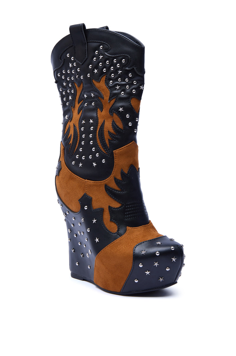 The AZALEA WANG CALLIA BLACK MULTI WESTERN WEDGE BOOTIE features a high wedge, mid-calf shaft, black and brown faux leather with flame patterns, silver studs, and star accents on heel and toe, shown against a white background.