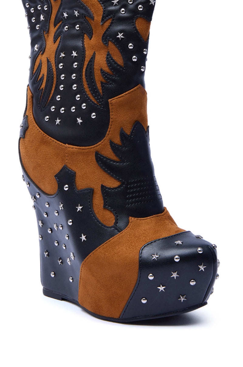 A close-up of the AZALEA WANG CALLIA BLACK MULTI WESTERN WEDGE BOOTIE in brown and black faux leather, mid-calf height, featuring silver studs and star-shaped accents on the heel, toe, and upper.