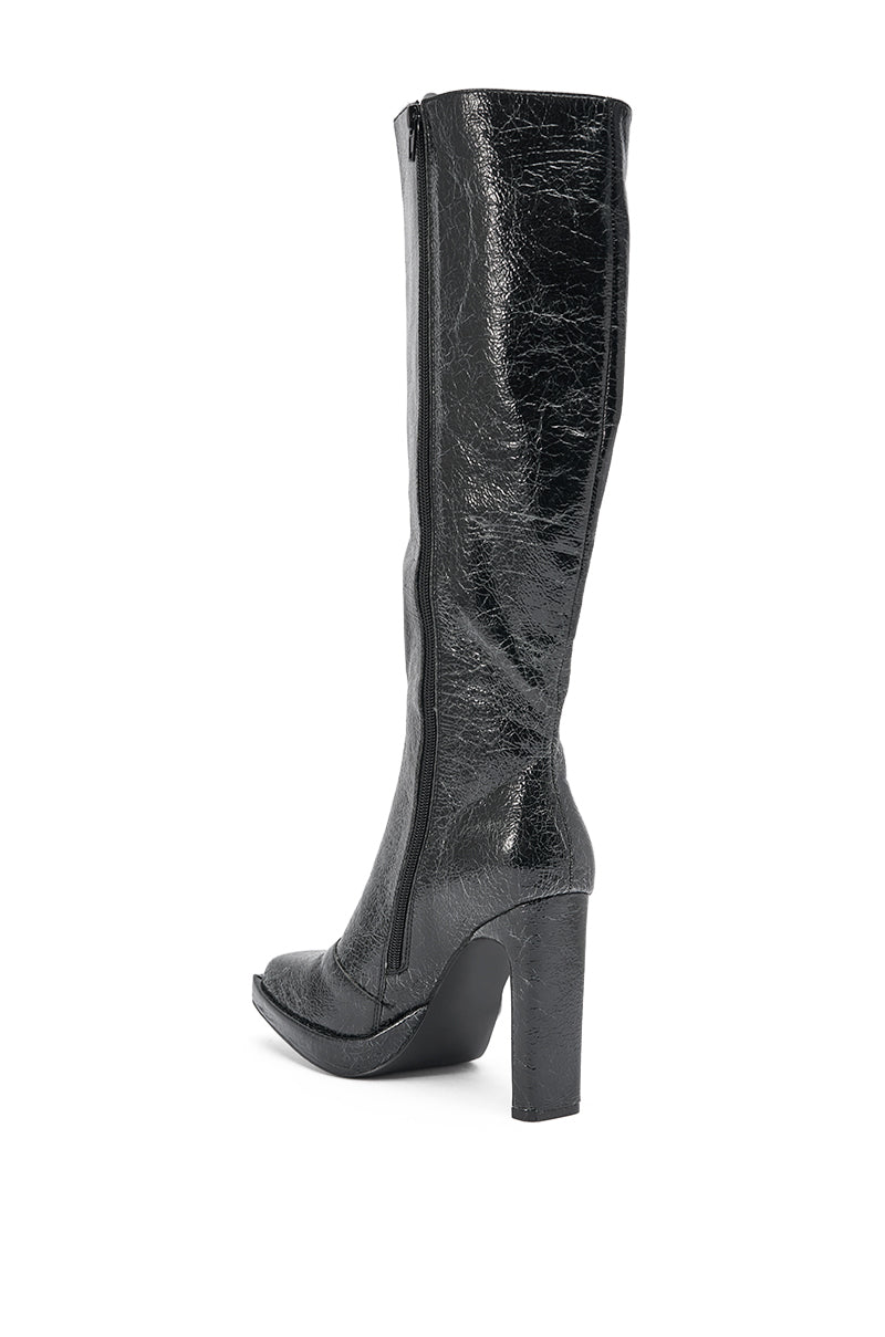 The AZALEA WANG CANCER BLACK DRESSY CHUNKY HEEL BOOT is a tall, shiny black faux leather knee-high boot with a side zipper and high block heel, shown from a side angle on a white background. 4