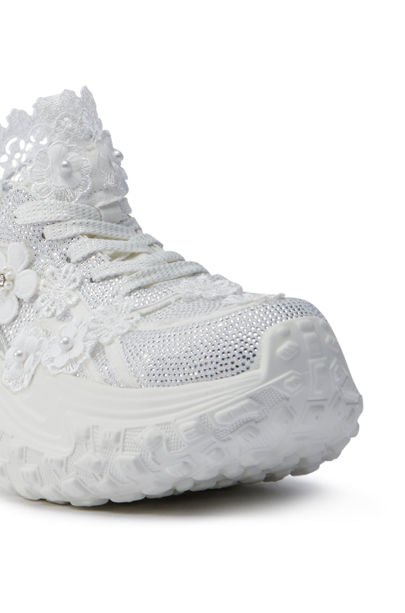 Close-up of the AZALEA WANG CANISH WHITE EMBELLISHED SNEAKER featuring a platform sole. The shoe is adorned with intricate lace flowers, sequins, and mesh accents, providing a textured and decorative look. This embellished sneaker beautifully combines elegance with modern style.