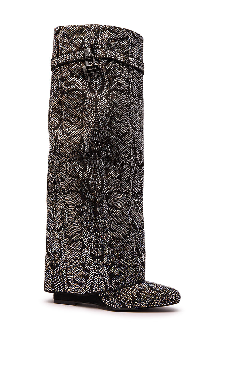 The AZALEA WANG CAPRICORN boot is a tall, slouchy knee-high style with a black and white snake pattern, rhinestone details, a wedge heel, rounded toe, and fold-over design.