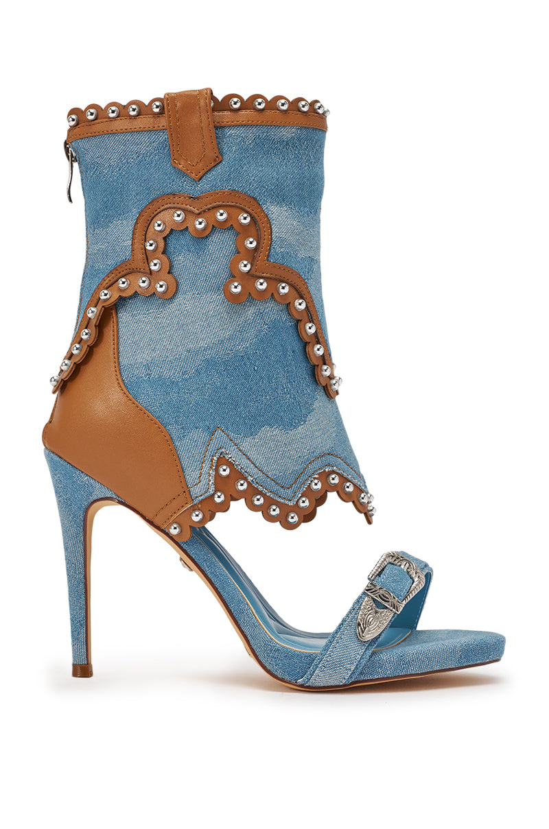 The AZALEA WANG CAPRIZIA DENIM WESTERN NOVELTY STUDDED STILETTO SANDAL features a denim and tan leather boot-style upper, silver eyelets, a decorative toe buckle, and scalloped edging for a western-inspired look. 4
