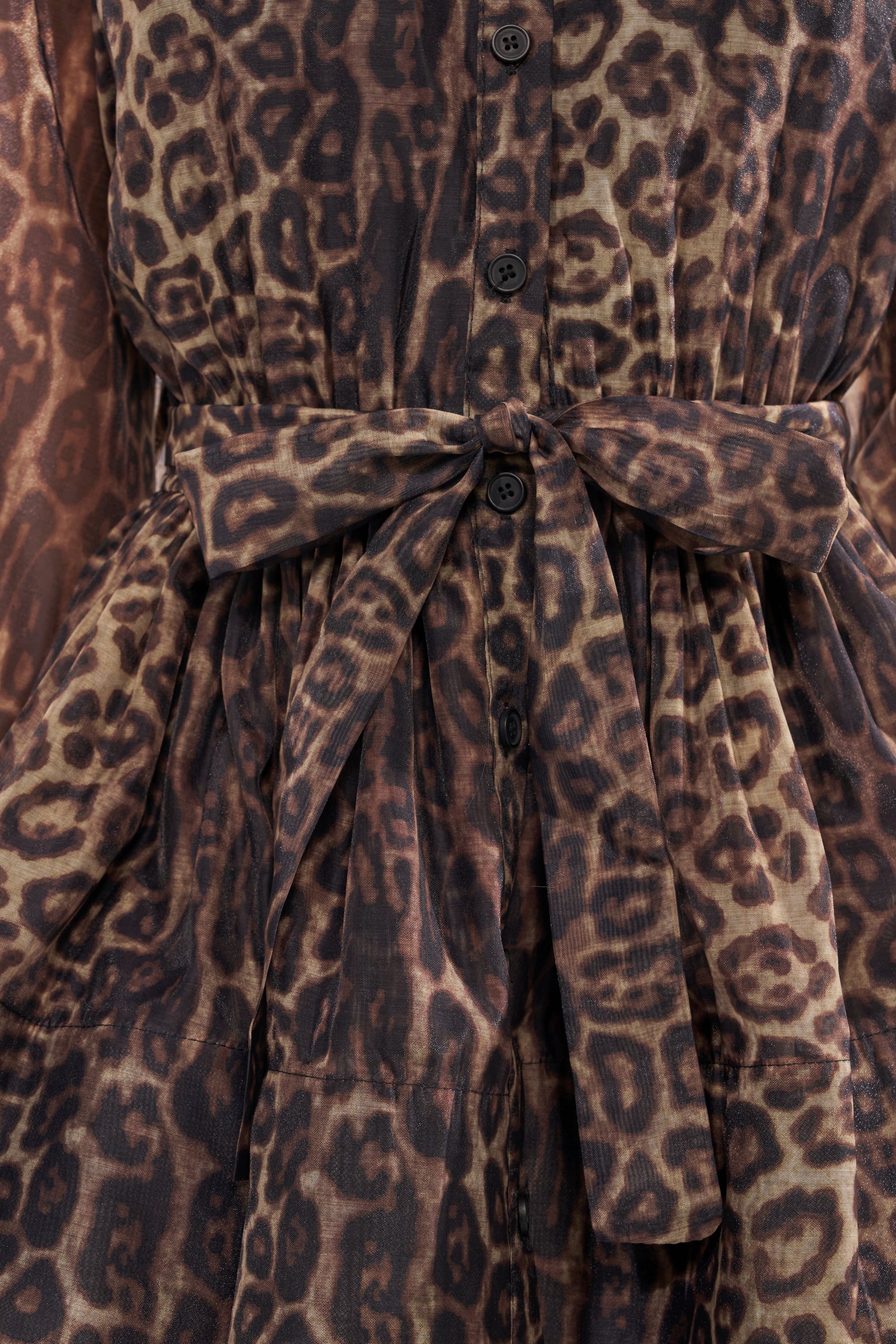Close-up of the CHICEST OF CHIC LEOPARD PRINT MINI DRESS with a tied waist belt and black front buttons.