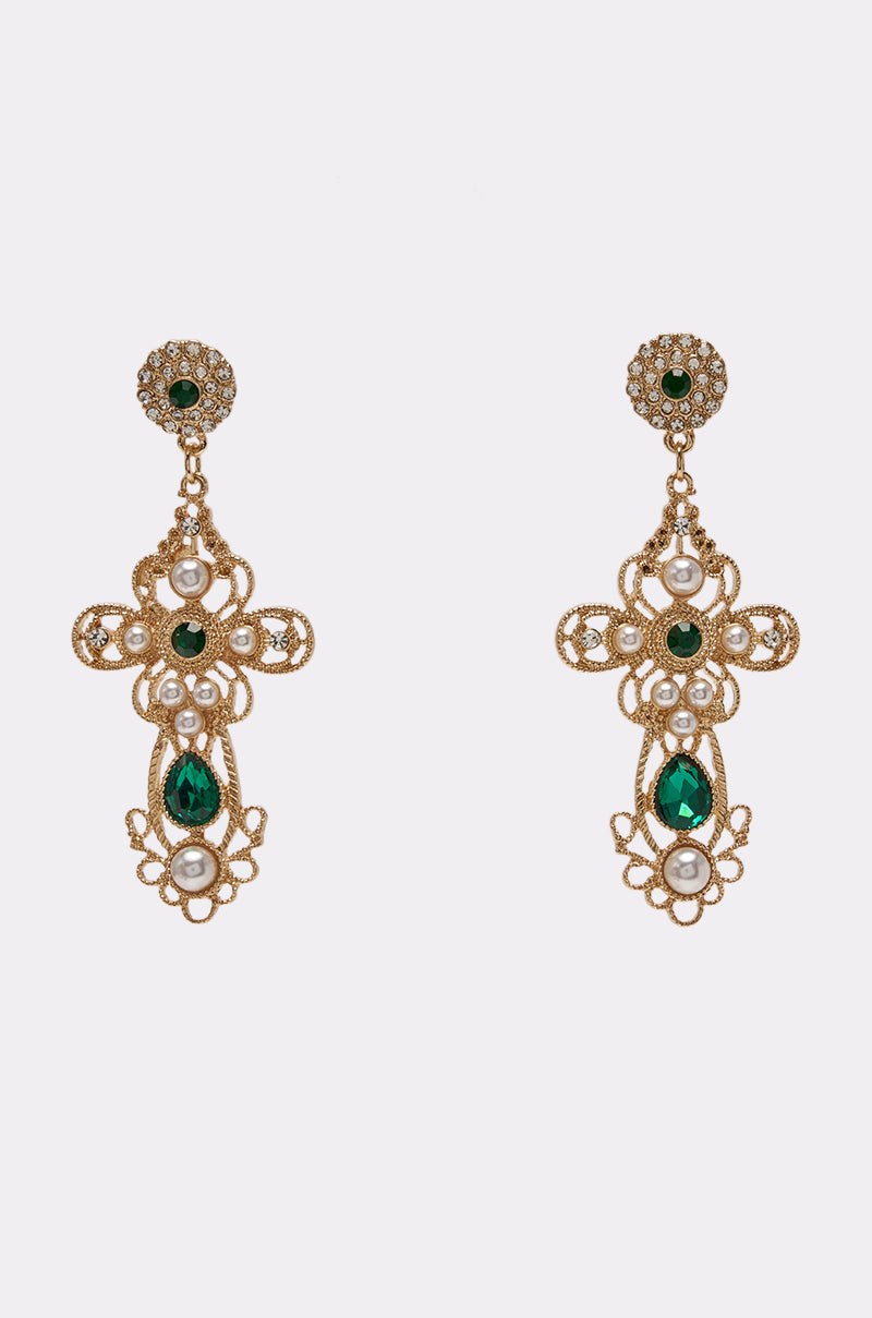The EMERALD JEWEL CROSS EARRINGS are an ornate pair of gold cross earrings adorned with green gemstones and luminous pearls, featuring an intricate filigree design. Elegantly presented on a plain white background, these pearl emerald earrings make a stunning choice for wedding guest jewelry.