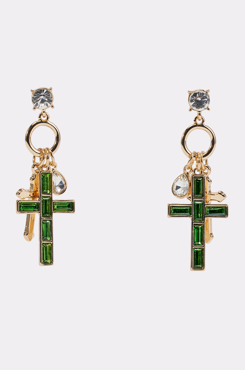 REGAL CROSS CHARM EARRINGS featuring gold statement design with green cross pendants, clear gemstone studs, and dangling charms—including clear teardrop-shaped stones—are showcased against a plain white background.