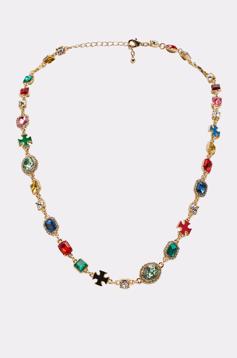 The I AM HER NECKLACE is a gold chain adorned with colorful gemstones in various shapes and sizes, featuring small, multicolored cross-shaped charms throughout. 0