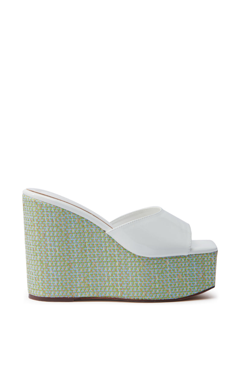 Side view of the AZALEA WANG CHANDRIA WHITE TWEED WEDGE SANDAL showcasing a white tweed upper with an open square toe. The wedge is wrapped in greenish-blue woven material and features a stylish platform sole. 3