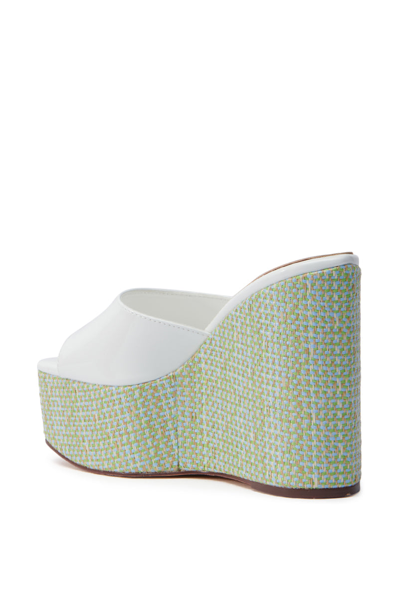 The AZALEA WANG CHANDRIA WHITE TWEED WEDGE SANDAL boasts an open square toe, white strap, and a high platform heel adorned in a textured green and blue pattern, complemented by a contrasting brown sole. 5