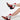 Two legs in AZALEA WANG CHANNING MULTI WESTERN BOOTIE with red and white faux leather, stars, and lightning bolt designs stand gracefully against a plain white background. These booties have angled chunky heels and studded details.