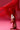 An individual is sporting AZALEA WANG CHANNING MULTI WESTERN BOOTIE, flaunting striking faux leather cowboy boots with star and flame motifs. These bold booties stand out against solid red fringe pants and feature an eye-catching chunky heel.