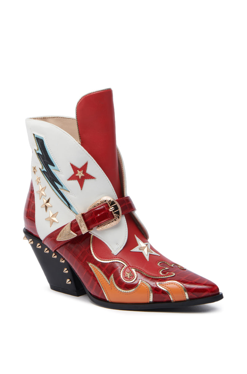The AZALEA WANG CHANNING MULTI WESTERN BOOTIE is a vibrant masterpiece, featuring a pointed toe, distinctive angled heel with small studs, and multicolored stars, zigzag patterns, and flame designs in red, white, orange, and black.