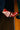 Someone wearing the AZALEA WANG CHANNY MULTI BOOTIE GRAPHIC WESTERN WITH STUDS, featuring star and lightning bolt designs and a chunky heel, rests their foot on the edge of a wooden pool table by a pocket.