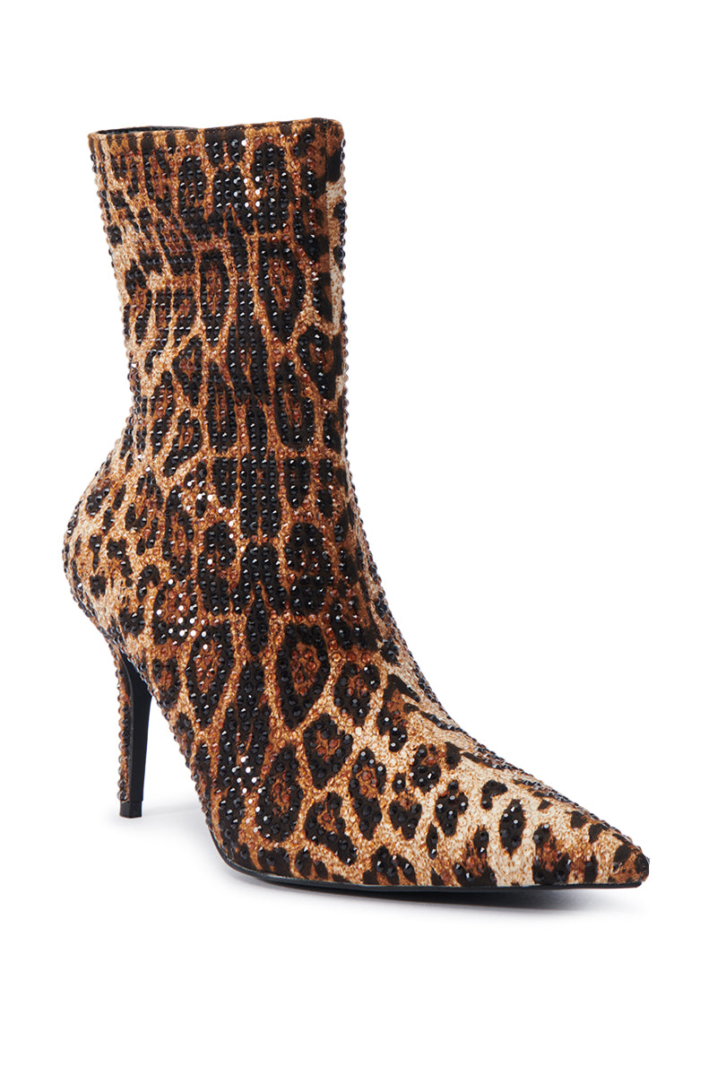 The AZALEA WANG CHAUNDRA LEOPARD EMBELLISHED STILETTO BOOTIE is a stunning high-heeled bootie featuring a leopard print and pointed toe, dazzlingly adorned with rhinestones. The sparkling embellishments add a glamorous touch to the entire boot, making it a standout piece for any fashion-forward ensemble. 4