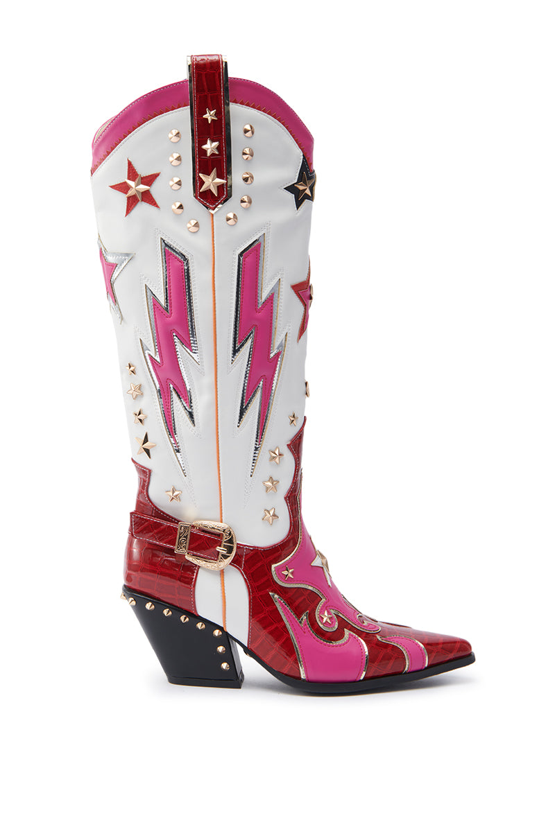 The AZALEA WANG CHEONA Red Multi Western Boot is a tall, pointed-toe, knee-high boot in faux leather with lightning bolt designs, star accents, gold studs, and a chunky angled heel on white, red, and pink panels.