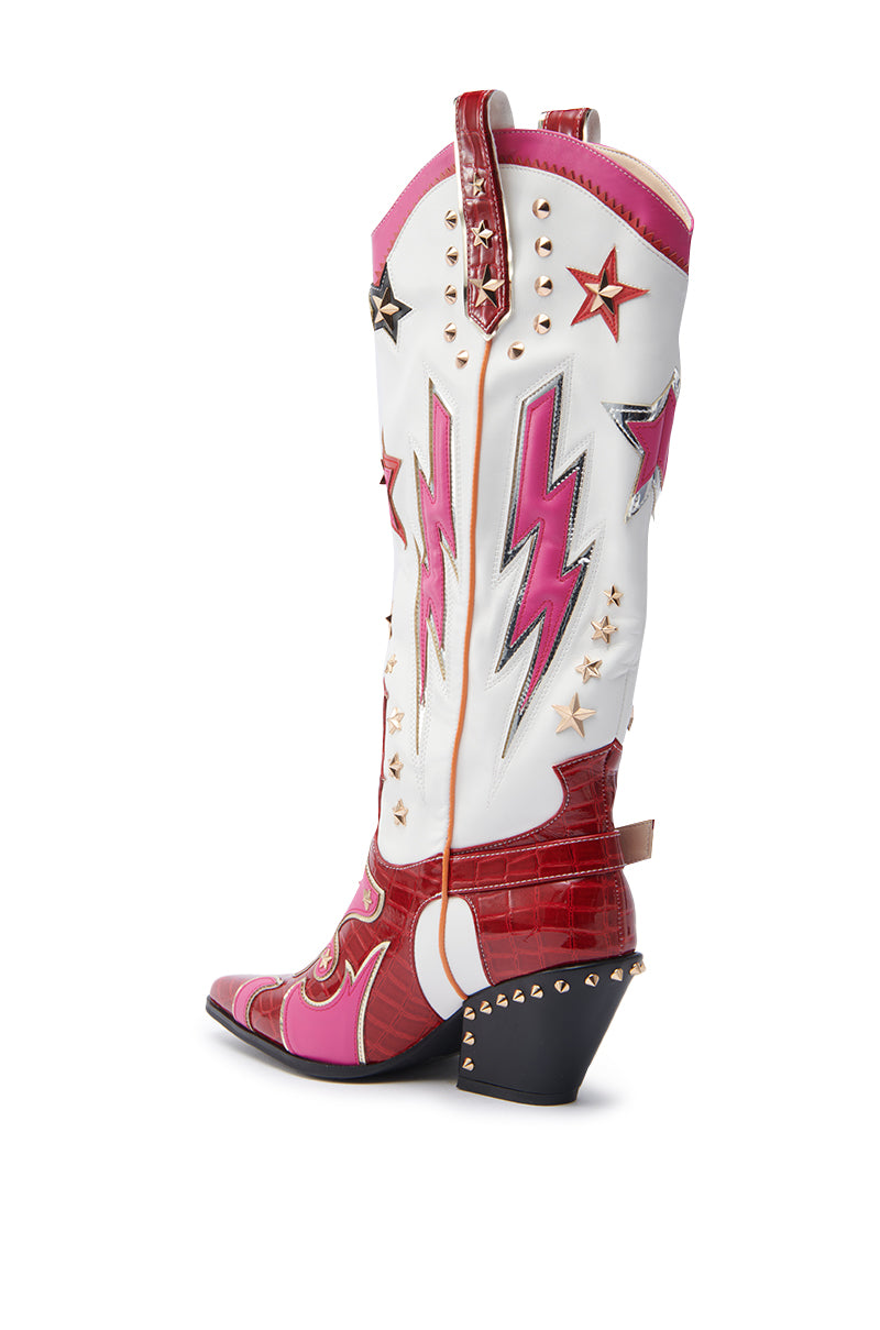 The AZALEA WANG CHEONA RED MULTI WESTERN BOOT is a bold faux leather style with red, white, and pink accents, star and lightning bolt details, gold studs, a chunky heel, and a textured red lower section.