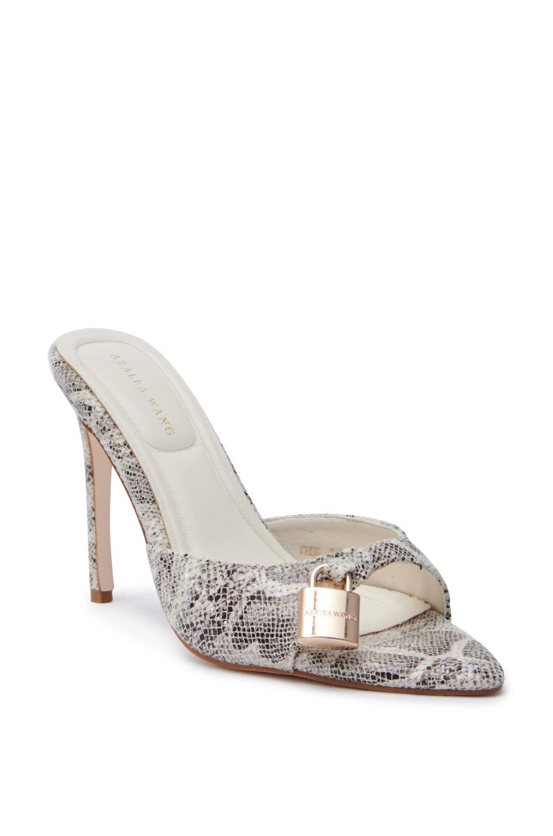 The AZALEA WANG CHUG SNAKE SANDAL is a high-heeled stiletto mule with a faux snakeskin pattern, pointed toe, decorative gold padlock on the front strap, and a light beige insole featuring a designer logo for an elegant finish.