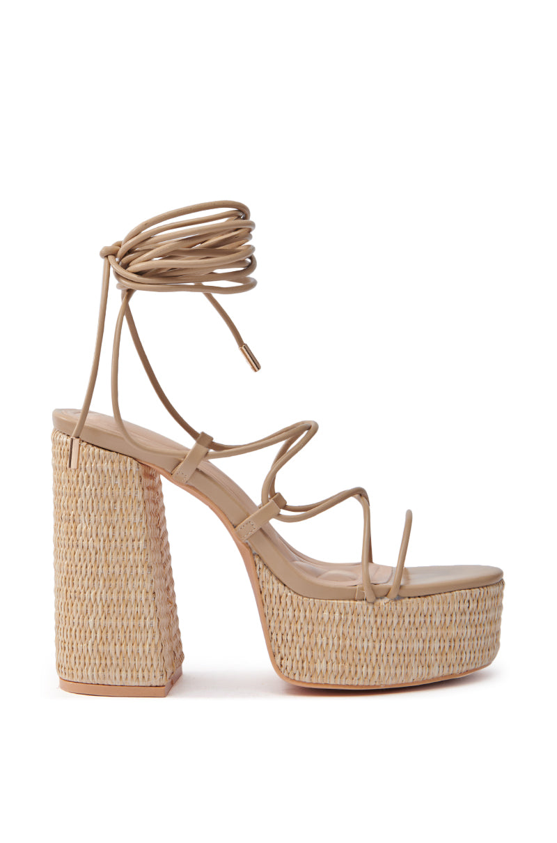 The AZALEA WANG CIERRA Beige Strappy Raffia Platform Sandal has ankle wrap straps, an open toe, a high chunky heel, textured woven design, and a comfort cushion insole for all-day wear.