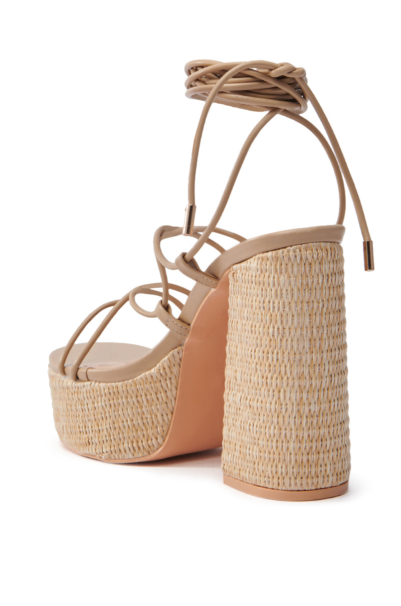 The AZALEA WANG CIERRA Beige Strappy Raffia Platform Sandal boasts a comfortable cushion insole, chunky rounded heel, woven texture, and ankle wrap strap. Its sleek straps give it a summery, casual vibe perfect for effortless elegance.