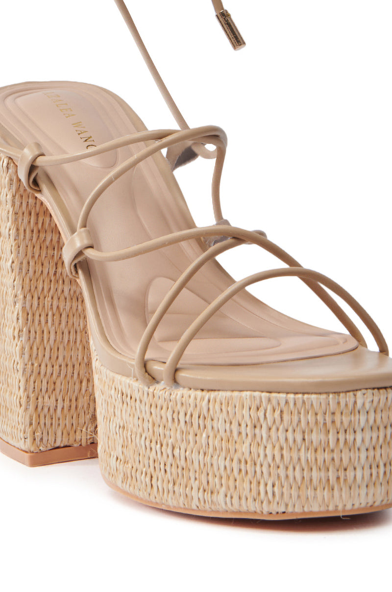 Close-up of the AZALEA WANG CIERRA BEIGE STRAPPY RAFFIA PLATFORM SANDAL featuring a chunky heel and thick straw-like platform for a natural, summery vibe. Enhanced with a comfort cushion insole crafted from smooth, matching beige material for extra ease.