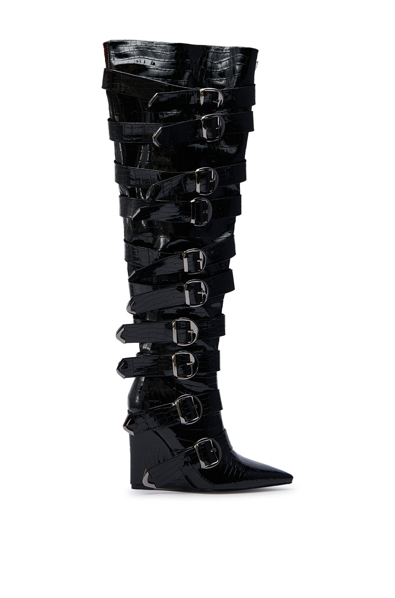 The AZALEA WANG CINZIA Black Croc Buckle Wedge Boot is an over-the-knee, faux leather boot with a pointed toe, wide straps, and large silver buckles running up its tall wedge silhouette.