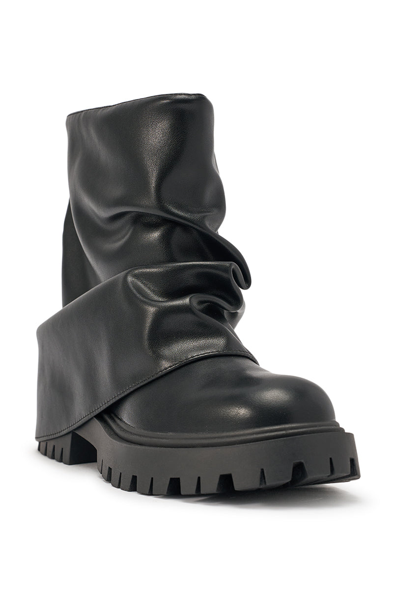 The AZALEA WANG CLARKE BLACK PU SLOUCHY SHORT SHAFT COMBAT BOOTIE features a unique fold-over draped design across the front and side, set on a chunky ridged lug sole for extra edge. 5