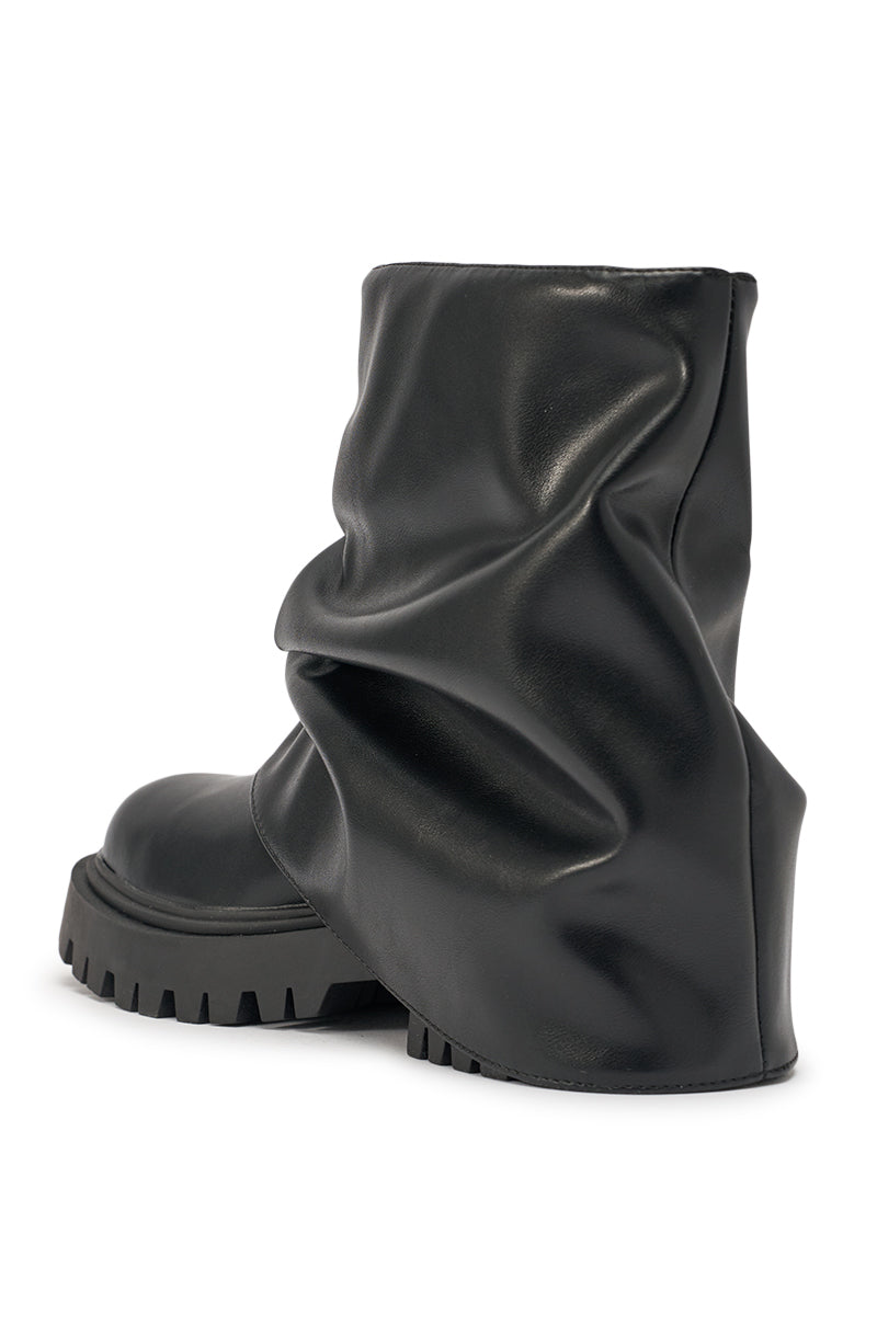 The AZALEA WANG CLARKE BLACK PU SLOUCHY SHORT SHAFT COMBAT BOOTIE features a thick, rugged lug sole and an intentionally wrinkled, slouchy design around the ankle and heel. 6