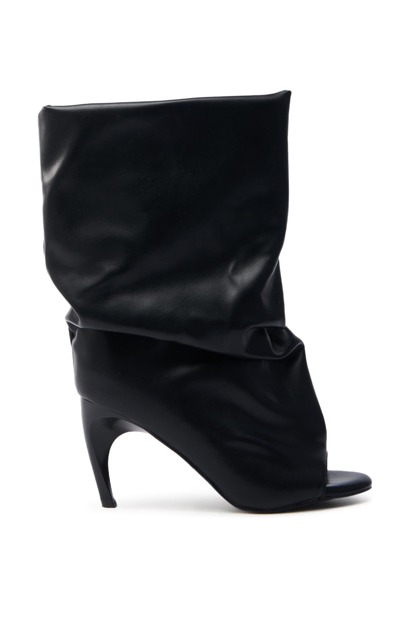 The AZALEA WANG CLASSIE black bootie is a faux leather shoe featuring a slouchy, ruched design, open toe, narrow banana heel, and leg wrap-around style for a modern look.