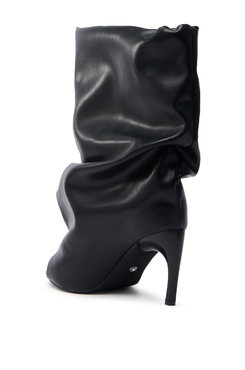 The AZALEA WANG CLASSIE BLACK OPEN TOE BANANA HEEL BOOTIE, featuring a slouchy faux leather design with a smooth texture and glossy finish, offers modern elegance with its slender tapered heel for a chic style.