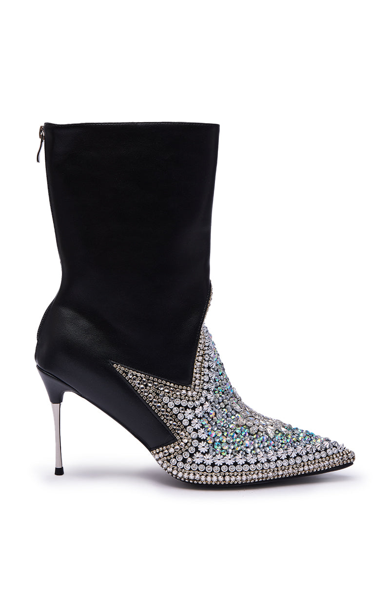 The AZALEA WANG CLINEQ EMBELLISHED RHINESTONE STILETTO BOOTIE is a high-heeled ankle boot with a pointed toe, sparkling rhinestones on the front and toe, sleek black faux leather upper and heel, and a back zipper.
