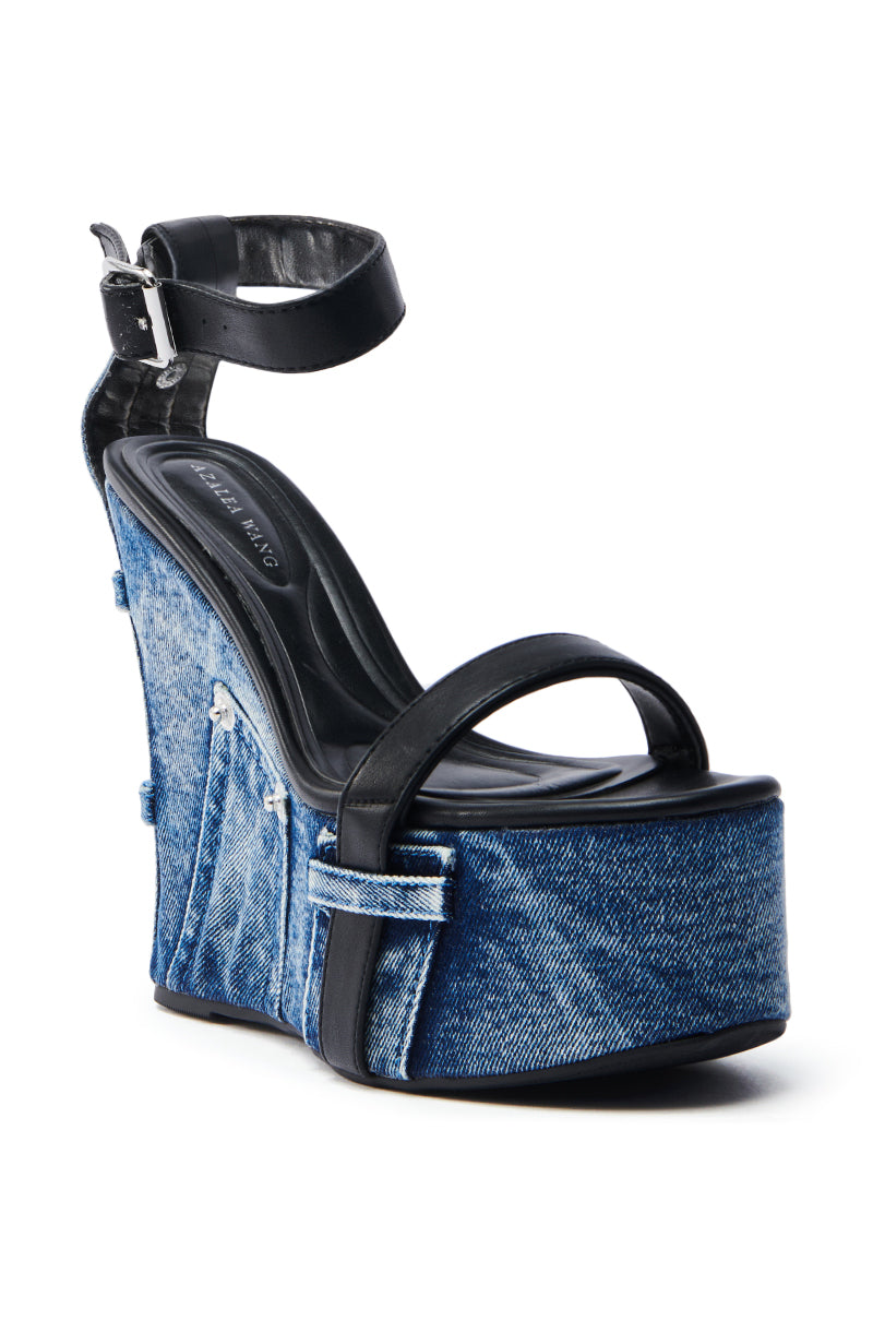 The AZALEA WANG CLIO DENIM SANDAL features a fashionable denim-covered wedge platform, black leather ankle straps with buckles, a stylish side zipper on the wedge heel, and a black branded insole.