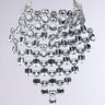 The AKIRA Label PAY MY BILLS NECKLACE IN SILVER showcases a luxurious design with multiple tiers of large, clear, faceted gemstones arranged in a cascading pattern. This visually striking and elegant accessory features an adjustable lobster claw closure to ensure the perfect fit against any plain backdrop.