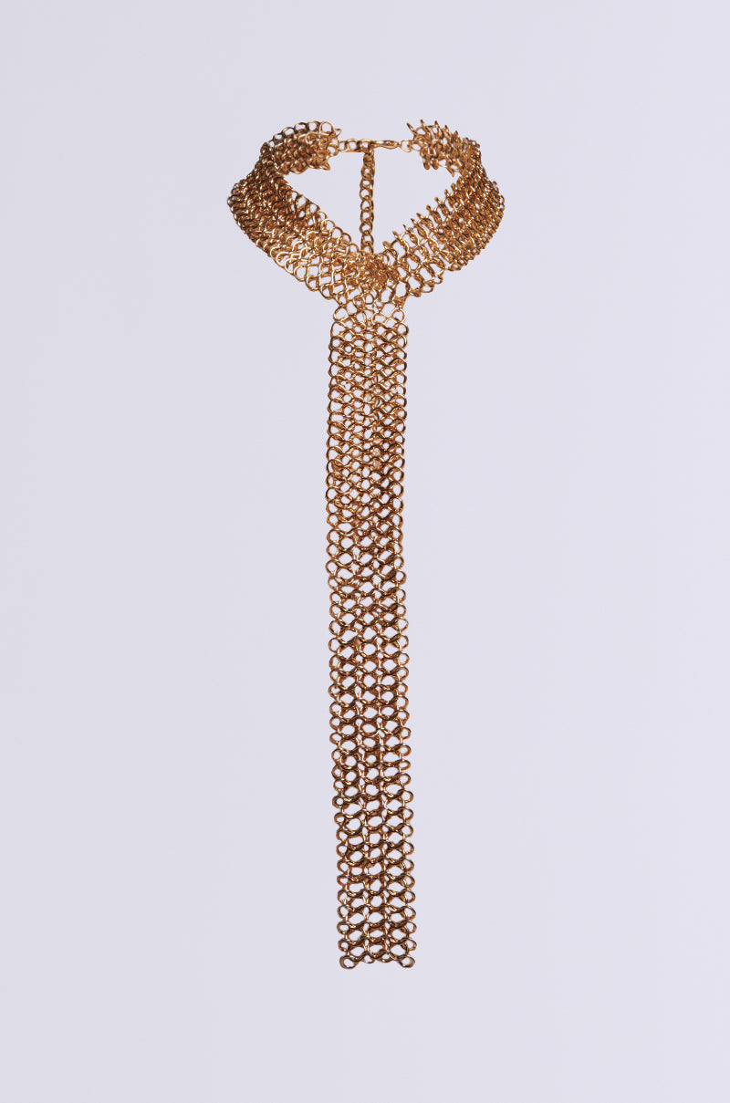 Introducing the IT GURL CHAINMAIL NECKLACE—a striking metallic faux gold piece crafted to resemble a tie, complete with intricate loop patterns and an extended dangling section at the front. This statement accessory effortlessly enhances any outfit with its distinctive design.