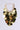 The ALL NIGHT LONG SEQUIN NECKLACE is a captivating party accessory, showcasing large, round metallic gold discs arranged in tiers. These discs are elegantly affixed to a gold chain with rectangular links, creating a dazzling, cascading appearance against the simple gray backdrop.