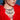 A woman in a vibrant red feathered outfit wears the PRETTY IN PEARLS NECKLACE—a bold, layered pearl and crystal piece—as she gazes to the side against a blue background.